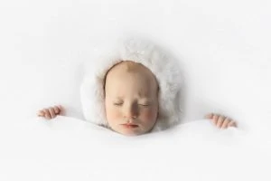 when can you give a baby a pillow and blanket
